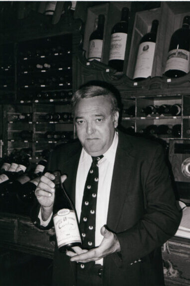 Sparks Owner Holding Wine Bottle Greyscale